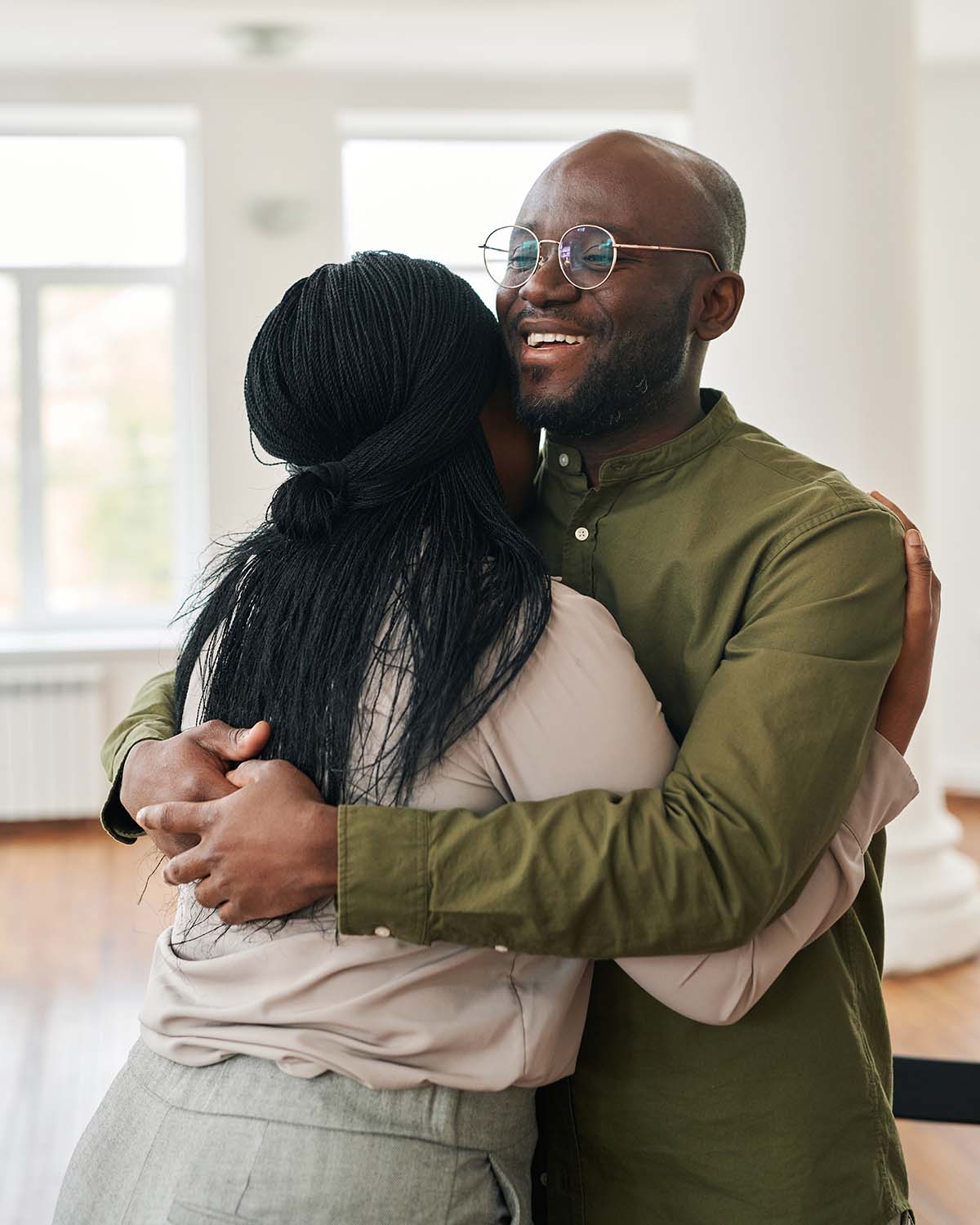 Two people sharing a warm, supportive hug